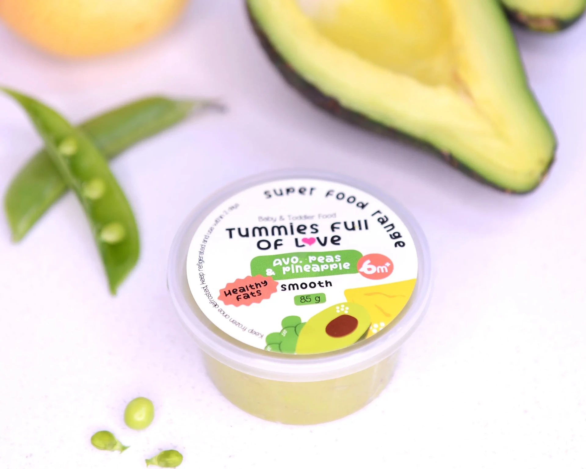 Tummies Full Of Love Super Food range tub of avo, peas and pineapple puree with fresh avocado and peas